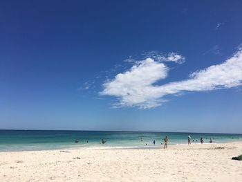 Scenic view of beach against blue sky