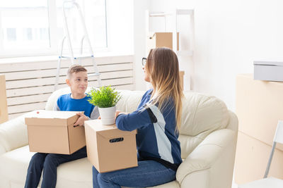 Young woman sitting in box