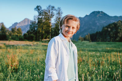 Portrait of smiling boy standing on land