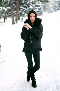 Young woman standing on snow