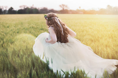 Side view of woman walking on field