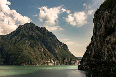 Scenic view of sea and mountains against sky