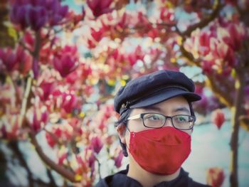 Close-up portrait of woman with red flowers