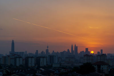 Buildings against sky during sunset