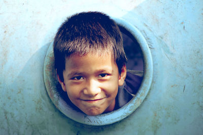 Portrait of smiling boy seen through play equipment