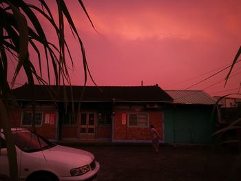 Red car against sky at night