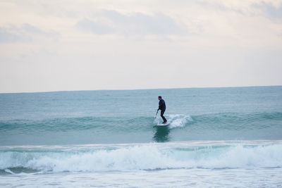 Man in sea against sky