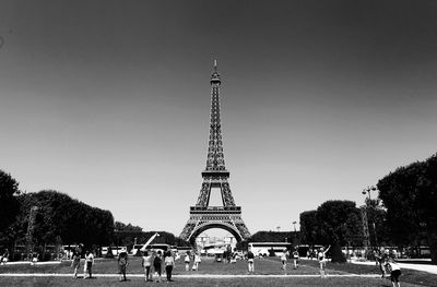 Tourists in front of building against clear sky