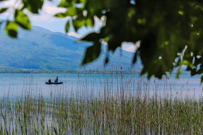 Lone silhouette boat in calm lake