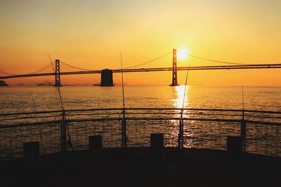 Silhouette of suspension bridge during sunset