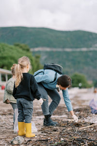 Rear view of family walking on field