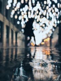 Defocused image of person walking on illuminated street at night