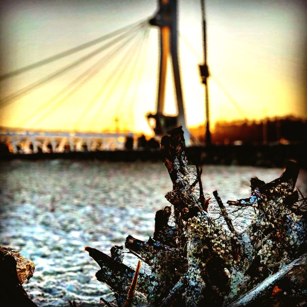 CLOSE-UP OF BRIDGE AGAINST SKY AT SUNSET