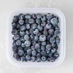 High angle view of blackberries in container on table