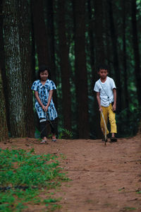 Full length of man standing in forest