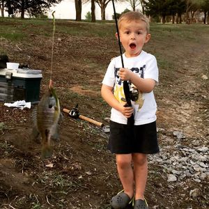 Portrait of cute boy fishing