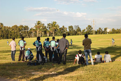 People on field against sky