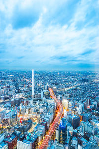 High angle view of illuminated city buildings against sky