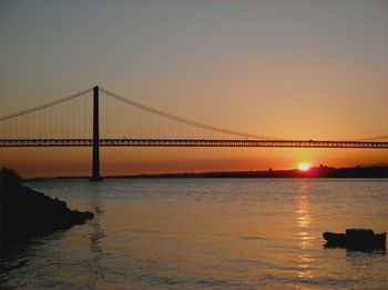 Bridge over sea during sunset