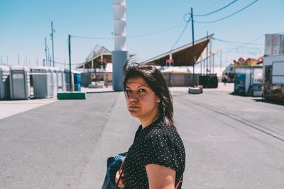 Woman standing by car against clear sky