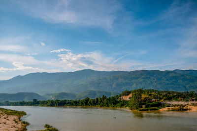 Scenic view of lake and mountains against sky