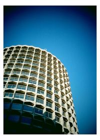 Low angle view of building against clear blue sky