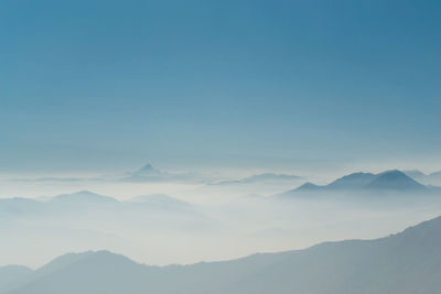 Scenic view of silhouette mountains against clear blue sky