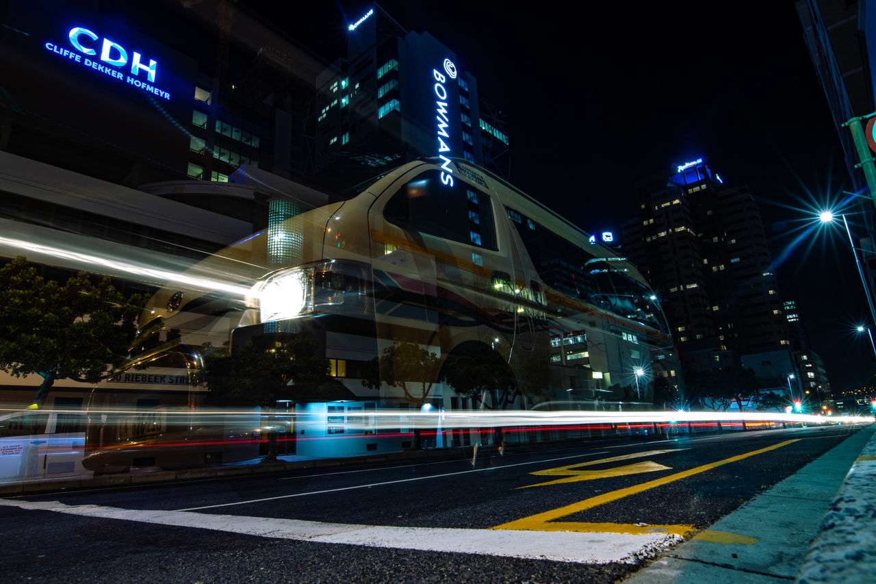 illuminated, night, road, city, transportation, light trail, architecture, street, sign, motion, long exposure, built structure, speed, building exterior, blurred motion, city street, no people, city life, symbol, mode of transportation, outdoors