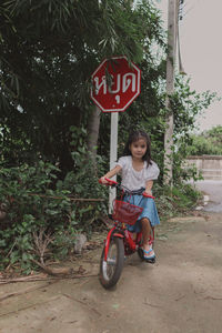 Portrait of man riding bicycle on road