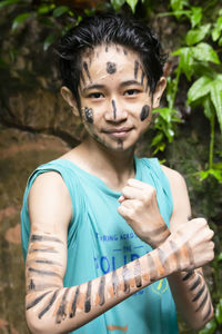 A boy with jungle make up