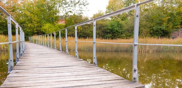 View of footbridge along plants