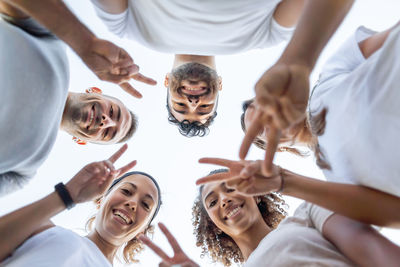 Low angle view of friends standing against people