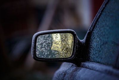 Snowflakes on side-view mirror of car