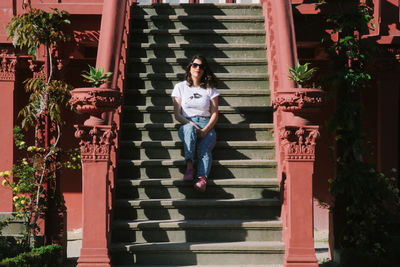 Portrait of woman sitting on staircase