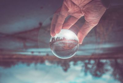 Close-up of hand holding crystal ball