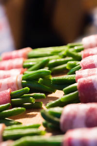 Close-up of bacon beans wraps on cutting board
