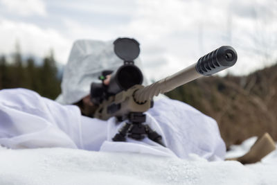 Close-up of men holding camera on land