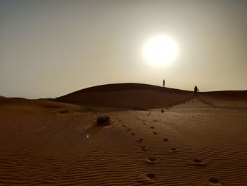 Scenic view of desert against sky during sunset