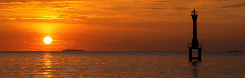 Scenic view of sea against orange sky