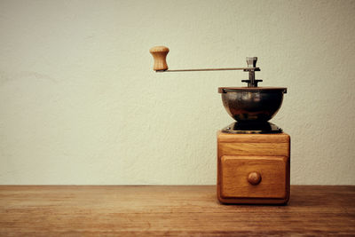 Coffee grinder on table at home