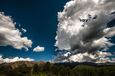 Scenic view of land and mountains against sky