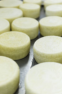 Full frame shot of cheese wheels on table