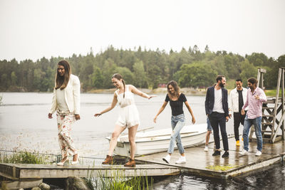 People enjoying in water against sky