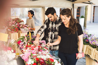 Couple buying flowers at market