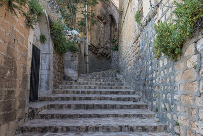 Low angle view of steps amidst buildings