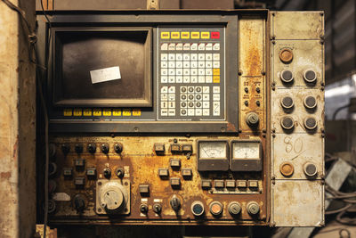 In an old mechanical engineering industry, there is a control panel and a machine valve.