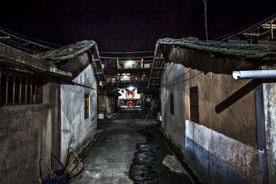 Street amidst buildings in city at night