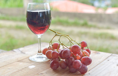 Close-up of grapes in glass on table