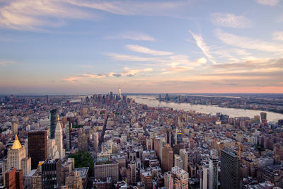 High angle view of modern buildings against sky during sunset