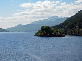 Scenic view of lake against cloudy sky